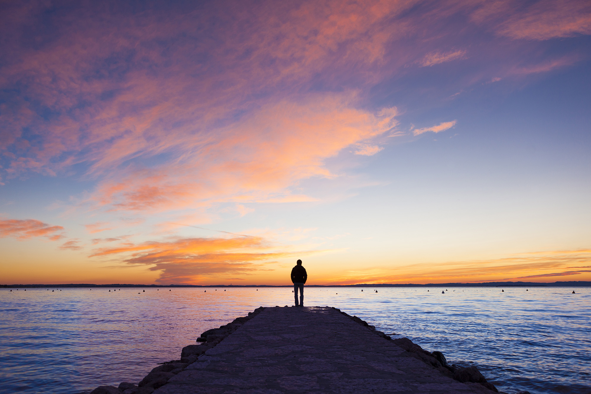 Silhouette of man standing by ocean